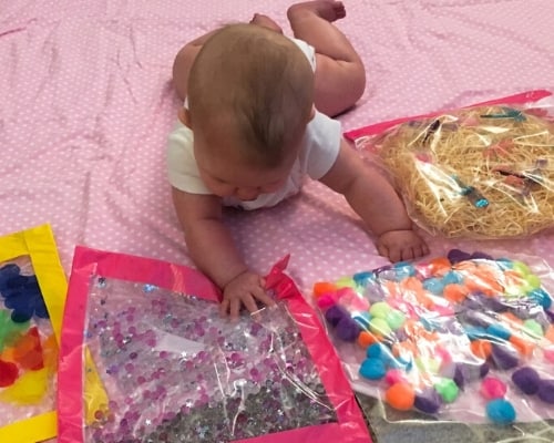 baby playing with sensory bags