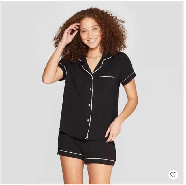 woman wearing black button down pajamas with short bottoms